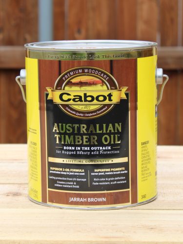 ATO cabot australian timber oil Can of Australian timber oil by cabot stain company in front of a fence