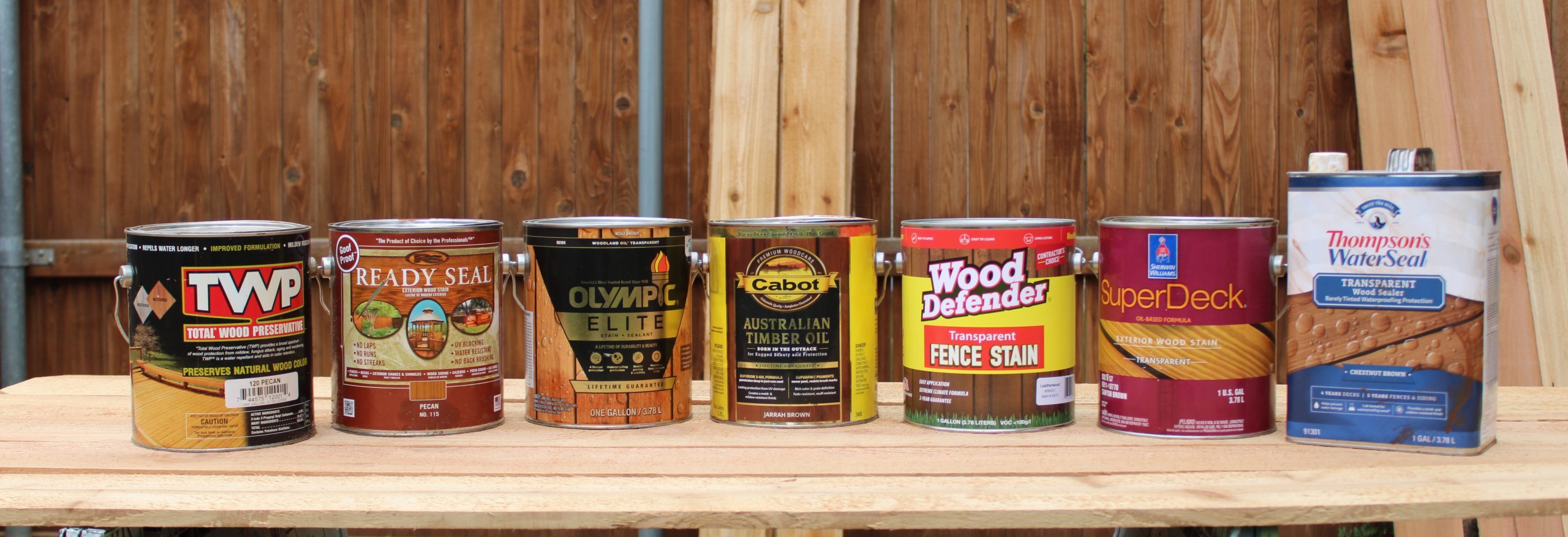 fence stain reviews lineup of stain cans ready for a fence stain review