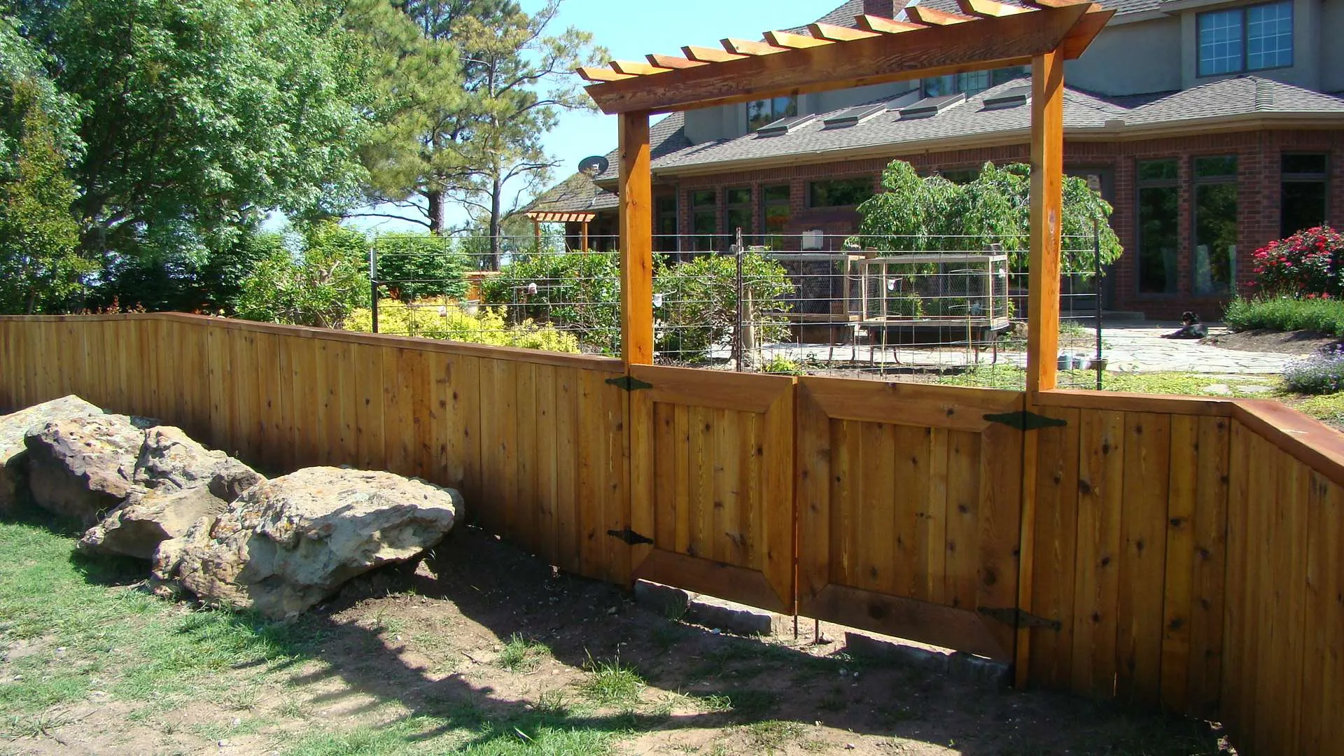 Sequoiah a wood fence with a light redish fence stain