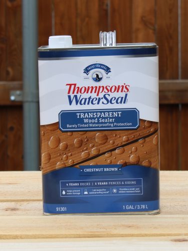 thompson's water seal can of Thompson's water seal stain in front of a fence